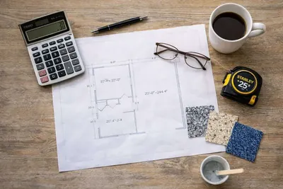 Floor plan, tape measure, calculator and flake color chips for pricing an epoxy floor